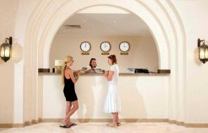 two women standing next to a counter in a room at Rohanou Beach Resort in Quseir