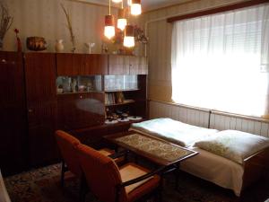a room with two beds and a table and a window at Holiday home in Balatonfenyves 38166 in Balatonfenyves