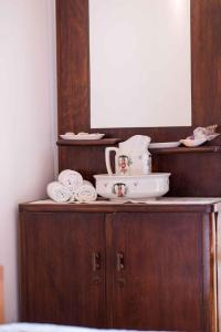a wooden cabinet with a mirror and towels on it at Apartment in Stivan - Insel Cres 37906 in Štivan