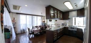 a kitchen and dining room with a table in it at Nakagawa's Cozy House in Sakai