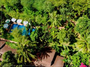 an overhead view of a garden with palm trees and a house at La Mer Resort, Phú Quốc in Phú Quốc