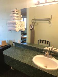 a bathroom with a sink and a mirror at Seahorse Inn in Manhattan Beach