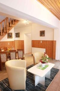 a living room with a table and chairs at Holiday home in Balatonkeresztur 37078 in Balatonkeresztúr