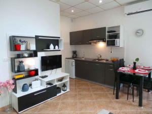 a kitchen with a table and a dining room at Apartment in Umag/Istrien 37005 in Umag