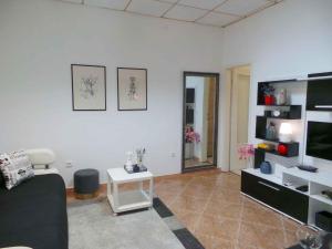 a living room with a couch and a tv at Apartment in Umag/Istrien 37005 in Umag