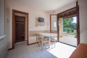a kitchen with a table and chairs in a room at Holiday Homes in Sirmione/Gardasee 22174 in Sirmione