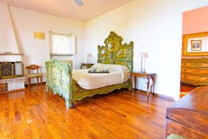 a bedroom with a large bed and a wooden floor at Holiday home in Portoferraio 23631 in Portoferraio
