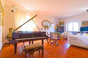 a living room with a piano and a couch at Holiday home in Portoferraio 23631 in Portoferraio