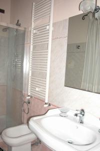 a bathroom with a sink and a toilet and a mirror at Apartments in Asciano/Toskana 24096 in Serre di Rapolano