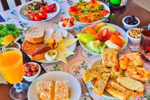 a table topped with plates of food and fruit at Hotel Sonne - Adults Only in Kaş