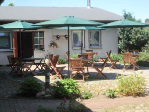 a group of tables and chairs with umbrellas at Studio in Ribnitz-Damgarten 36833 in Ribnitz-Damgarten