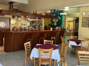 a restaurant with two tables and a bar at Hotel San Angel Cerca Del Acuario in Veracruz