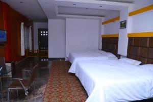 Postel nebo postele na pokoji v ubytování Celestial Resorts