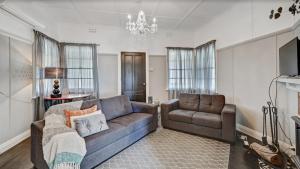 a living room with a couch and a chair at "Donnelly House" in Tenterfield