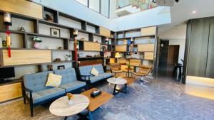 a lobby with a couch and tables and shelves at Meet Gaudi in Hualien City