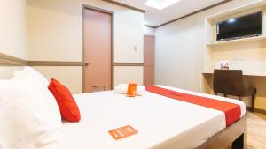 a hotel room with a bed and a tv at RedDoorz Plus at Canley Residential in Manila