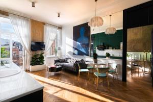 a living room with a couch and a table at Unfound Door - Design Hotel in Tbilisi City