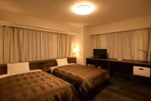 Uma cama ou camas num quarto em Sakura Shimanami Hotel