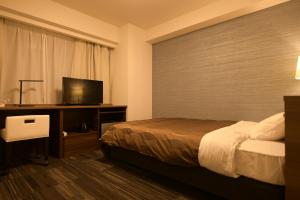 Uma cama ou camas num quarto em Sakura Shimanami Hotel