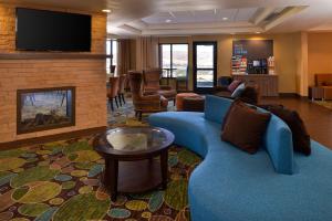 a living room with a blue couch and a fireplace at Holiday Inn Express Pocatello, an IHG Hotel in Pocatello