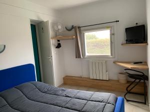a bedroom with a bed and a window and a desk at Hotel Macon la Salle in Mâcon +16 photos