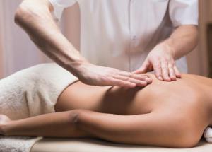 a woman getting a back massage from a therapist at Darino in Rodnikovka
