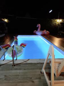a swimming pool with a swan and a swan toy at Little home poolvilla in Hua Hin