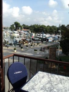 a balcony with a view of a marina with boats at Apartment Mandrač in Novigrad Istria