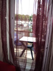 a view of a table and a window with curtains at Apartment Mandrač in Novigrad Istria