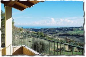 a balcony of a house with a view of the ocean at bed & breakfast CASA JO in Lapedona