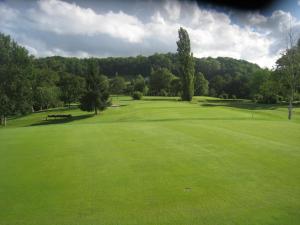a view of a golf course with a green field at Hotel Helios - Golf in Salies-de-Béarn