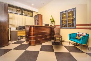 an office with a desk and a blue chair at AKWA HIN Douala in Douala