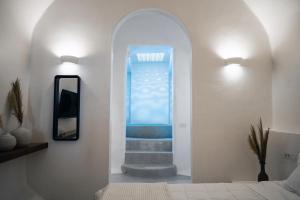 a hallway with a stairway leading to a blue window at Terra e Lavoro Luxury Suites in Éxo Goniá +41 photos