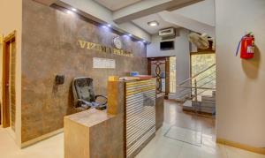 a lobby with a wall with a sign on it at Itsy By Treebo - City Centre Noida in Noida