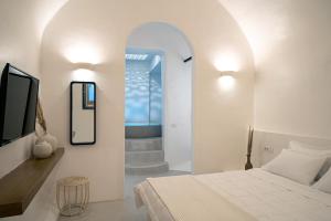 a bedroom with a bed and a mirror and a staircase at Terra e Lavoro Luxury Suites in Éxo Goniá
