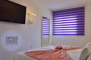A bed or beds in a room at El Dorado Sun Las Américas by Vapagó Tenerife