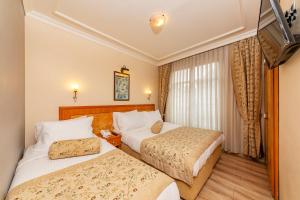Postel nebo postele na pokoji v ubytování Santa Ottoman Hotel