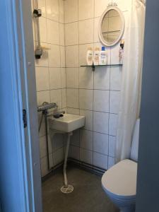 a bathroom with a sink and a toilet and a mirror at Puutaloasunto 1.8 km Turun aurajoelta in Turku +15 photos