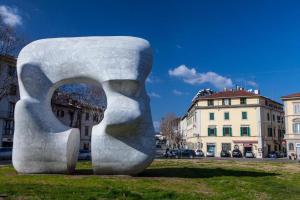 a large sculpture in the grass in a city at Affittacamere ACCASA in Prato