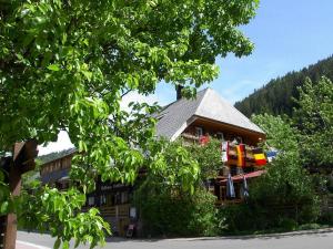 a building in the middle of a tree at Hotel Hirschen in Menzenschwand