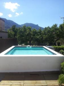 a large swimming pool with a white wall at CALM HOUSE in Sóller