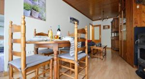 a dining room with a table and chairs and a fireplace at Luna Lunera in Biescas
