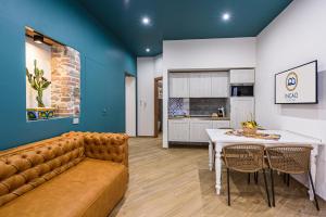 a living room with a couch and a table at Incao Holiday Il Moro House in Cefalù