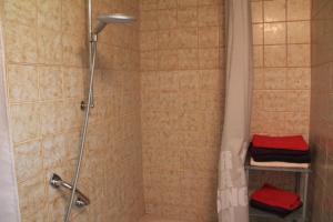 a bathroom with a shower with a red towel at Ferienhaus Landsberg Am Lech in Landsberg am Lech +44 photos