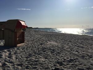 a beach with a life guard station on it at Kajüthus Apartment 6 in Fehmarn