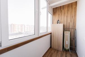 a room with a large window and a refrigerator at Комфортна та тиха квартира у Центрі міста in Ternopilʼ