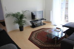 a living room with a television and a coffee table at Ferienhaus Landsberg Am Lech in Landsberg am Lech