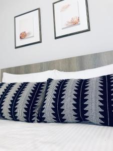 a bed with blue and white pillows on it at Xenia_Apartments A5 in Kozani