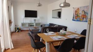 a living room with a table and a couch at Casa Altos 76 in La Herradura
