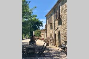 a group of chairs sitting outside of a stone building at Casa Majella di Casale Corneto in Bomba